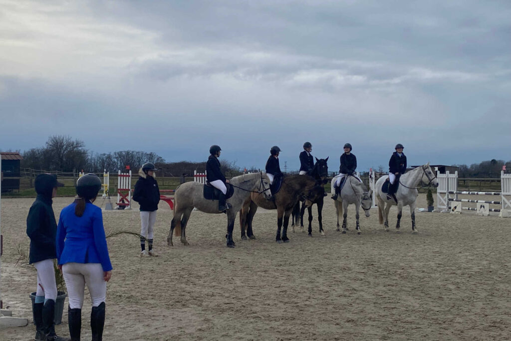 Les cavaliers reçoivent leurs prix à la fin de chaque épreuve, sur la carrière. Ils sont sur leurs chevaux, côte à côte.